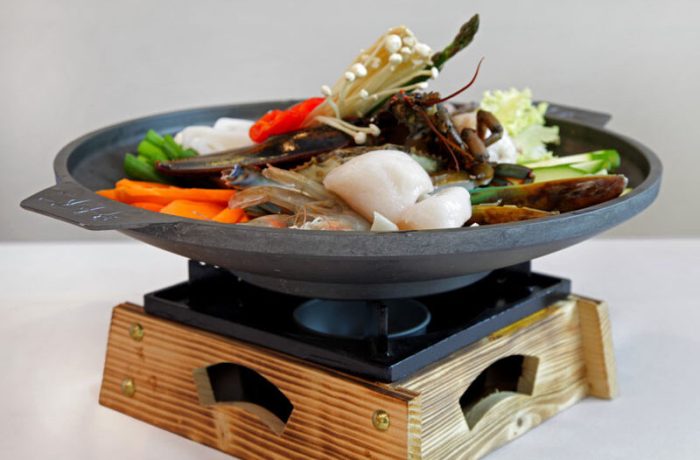 Seafood Gui <br> Marinated seafood grilled and servered on a hot sizzling pan.